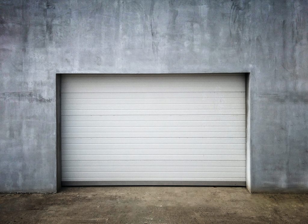 New Modern Garage Door in Unfinish Exterior Concrete Wall